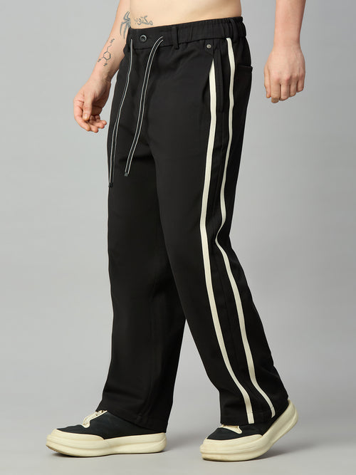 Men's baggy smart pants with athletic-inspired side stripe detailing – right side profile