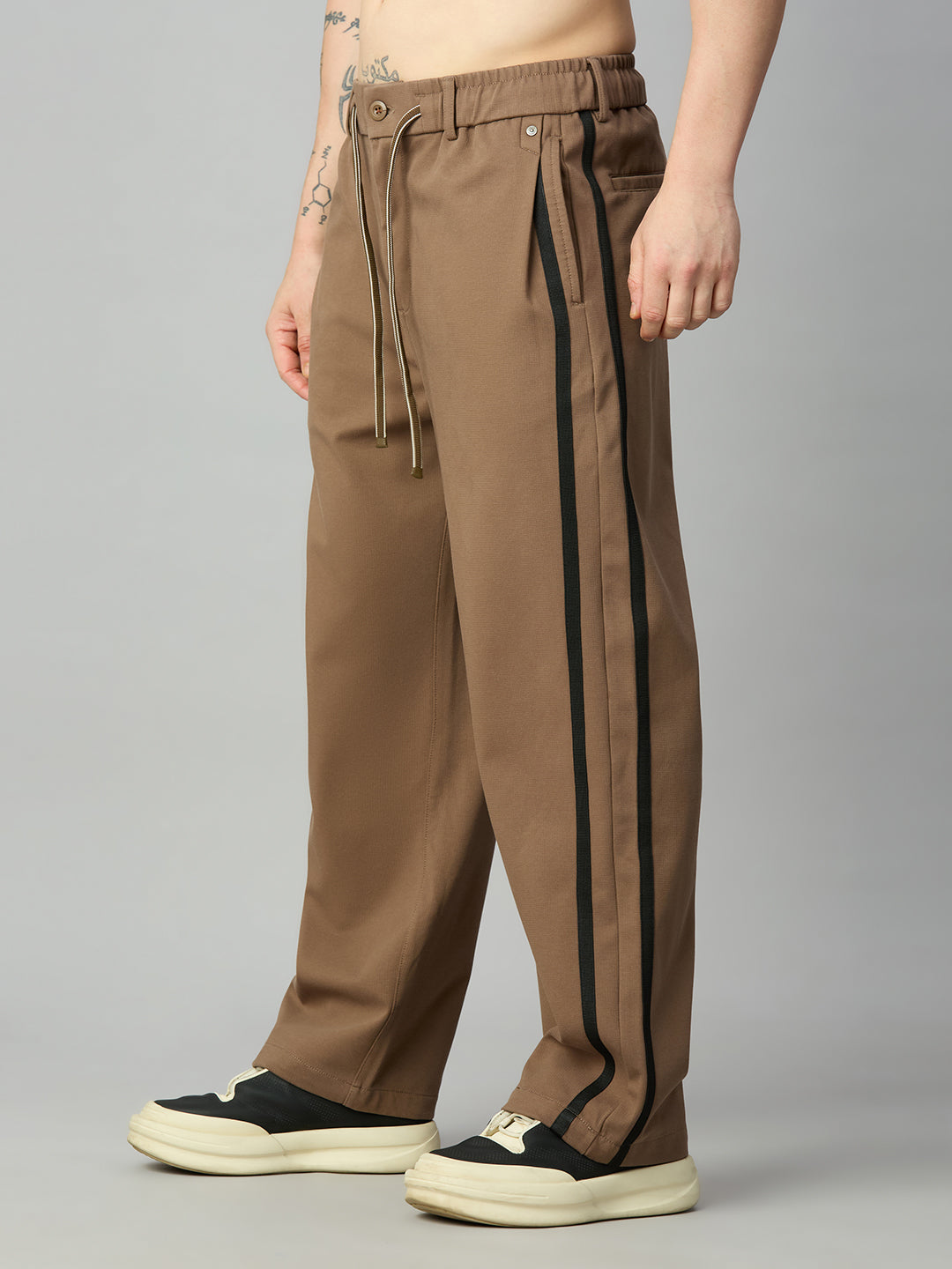Men's baggy smart pants with athletic-inspired side stripe detailing – right side profile