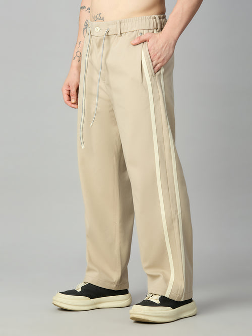 Men's baggy smart pants with athletic-inspired side stripe detailing – right side profile