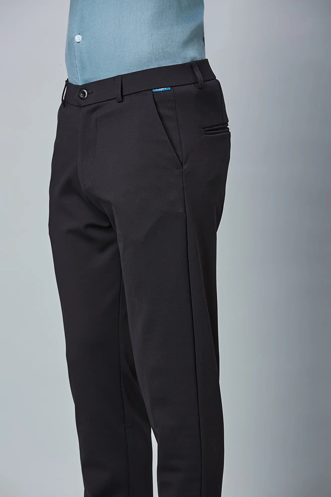 Close-up of nylon–cotton–spandex fabric and fine stitching detail of LOFA stretchable formal trousers.