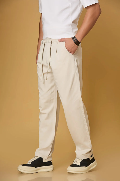 beige trousers side view showing smooth fabric and adjustable waist detail.