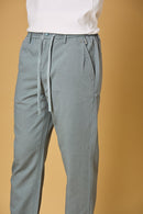 Close-up of waist string, press button, and fabric texture on Aqua Blue trousers.