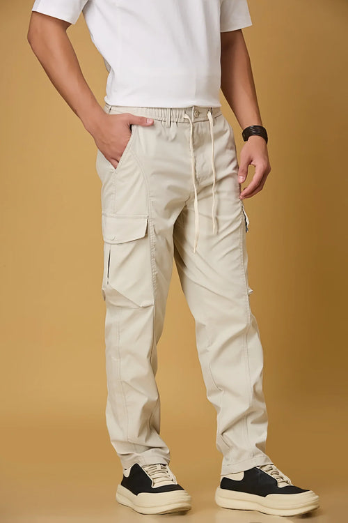 Beige cargo pants side view showing double cargo pockets and relaxed fit.