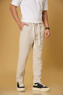 Beige trousers side view showing comfort fit and adjustable waist.