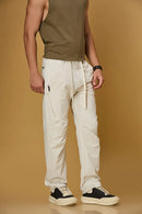 Beige stretchable trousers side view showing two side pockets and relaxed fit.