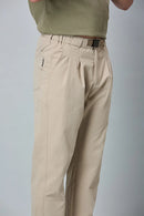 Close-up of khaki trousers belt, elastic waist, and pleated design details