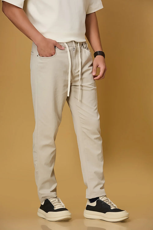 Beige stretchable trousers side view showing casual comfort fit.