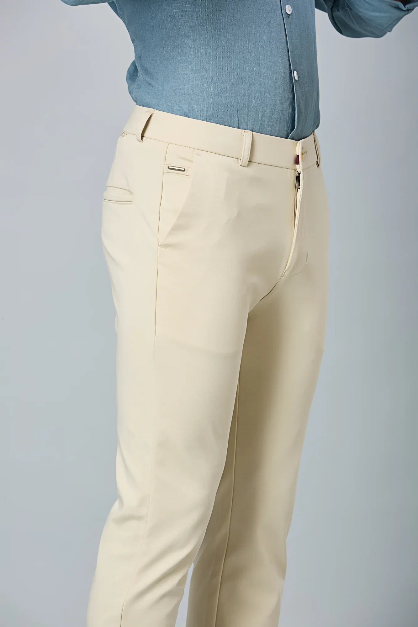 Close-up of cotton–polyester–spandex fabric showing fine stitching and smooth stretch texture of LOFA beige formal trousers.