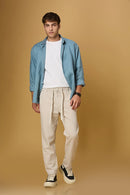 Men wearing LOFA beige Tencel-cotton trousers in a relaxed casual setting.