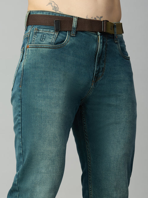 Close-up of attached adjustable web belt, waistband, and button closure on men's straight fit denim jeans