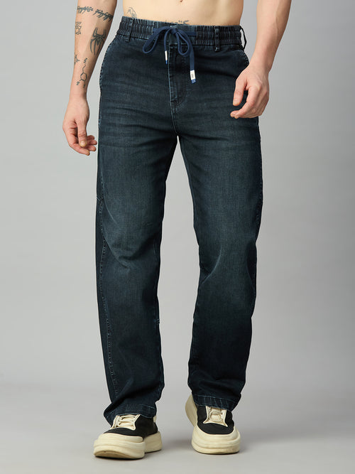 Men's baggy stretch denim jeans with green side stripes and elastic drawstring waist – front view