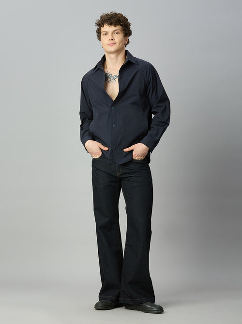 Model wearing The Lofa men's deep blue bootcut denim jeans styled for a modern casual look