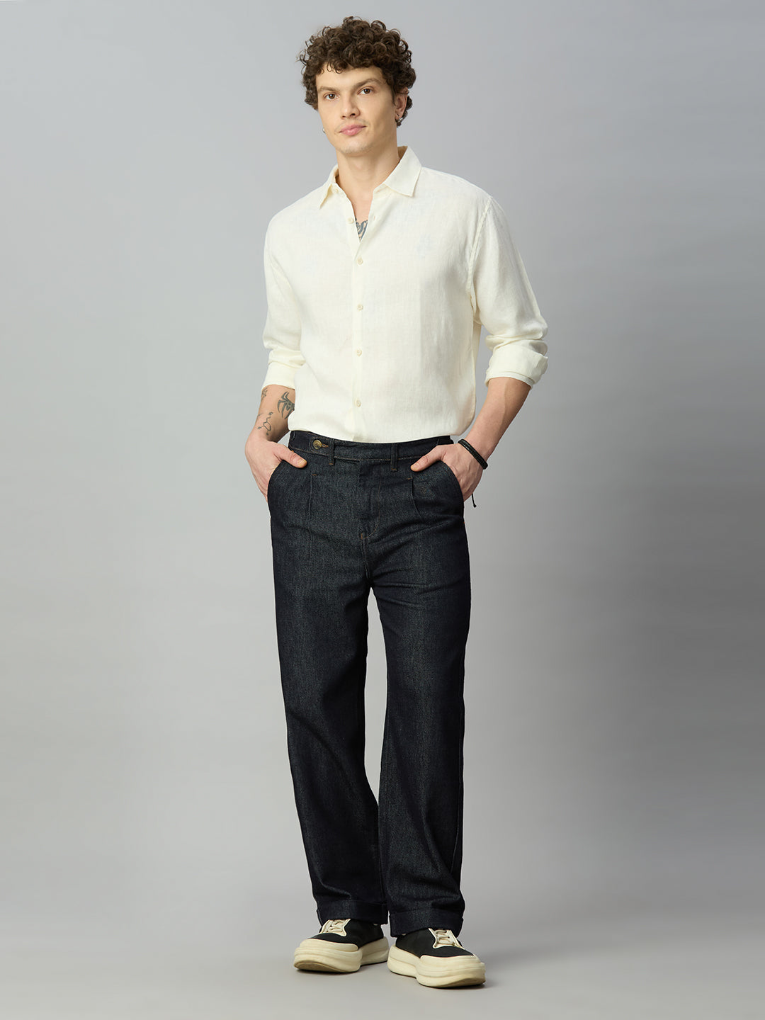 Model wearing The Lofa men's deep blue baggy denim jeans with side waist adjusters for a modern streetwear look