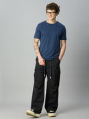 Model wearing relaxed fit cargo pants with casual streetwear styling