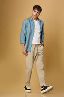 Men wearing LOFA light khaki Tencel-cotton trousers in a relaxed casual setting.