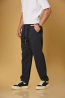 Navy blue trousers side view showing smooth fabric and adjustable waist detail.