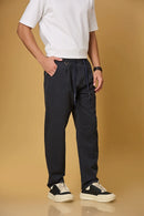 Navy blue trousers side view showing smooth fabric and adjustable waist detail.