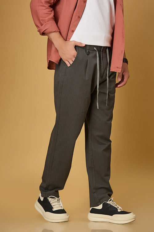 grey trousers side view showing smooth fabric and adjustable waist detail.
