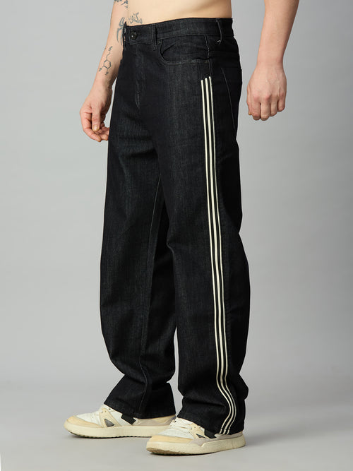 Premium raw black baggy jeans for men featuring athletic-inspired double side stripes – left side view