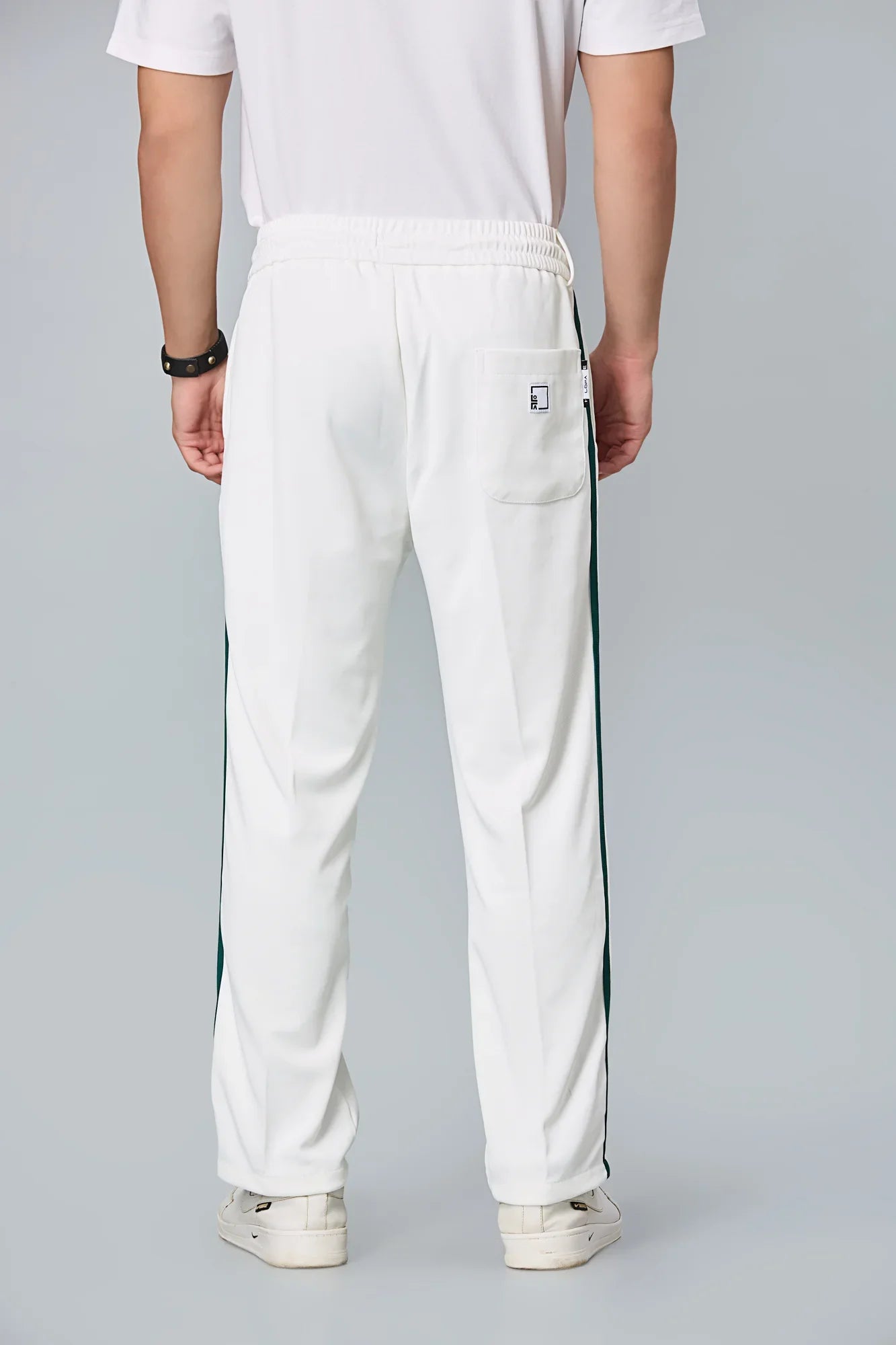 Back view of LOFA straight-fit men’s active pants – clean silhouette with wrinkle-resistant fabric.