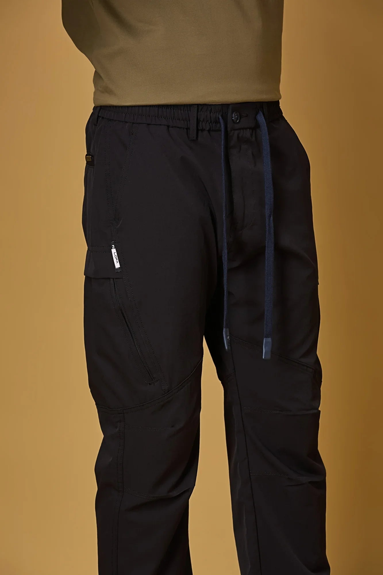 Close-up of Navy Blue trousers waist strings, side pockets, and smooth fabric texture.