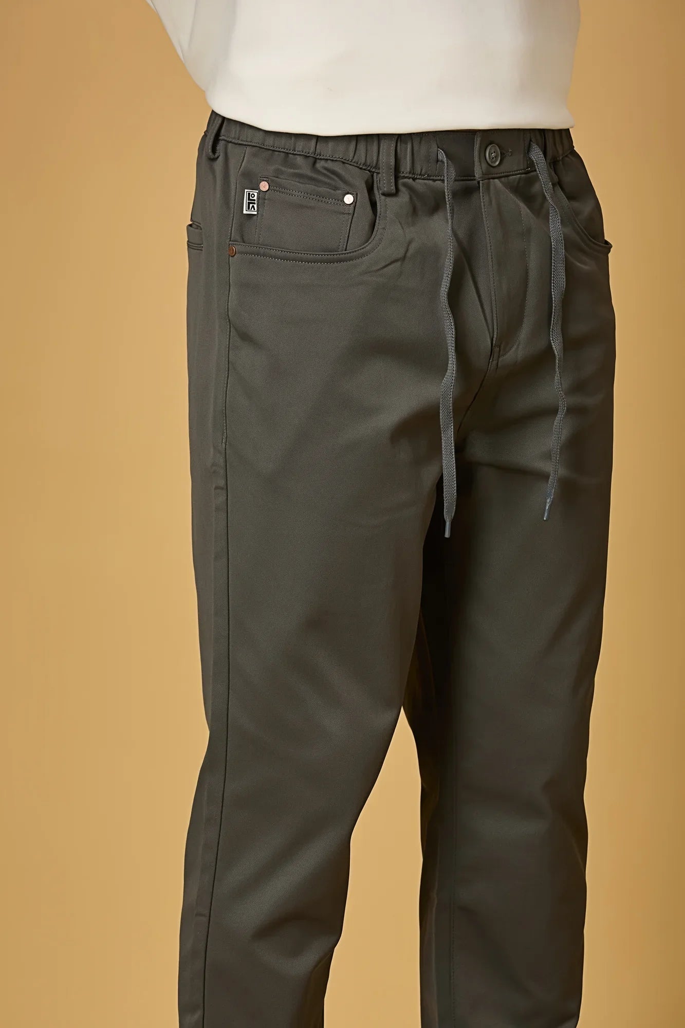 Close-up of grey polyester fabric texture showing smooth and stretchable finish.