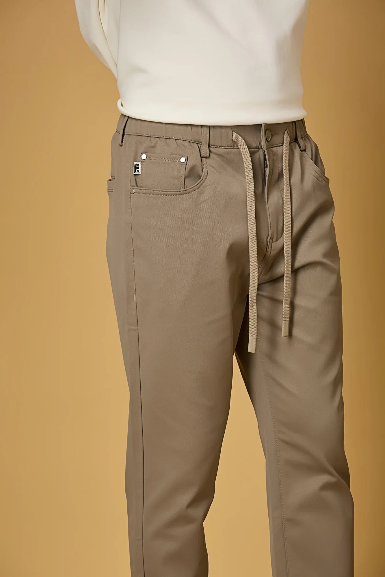 Close-up of Dark Khaki polyester fabric texture showing smooth and stretchable finish.