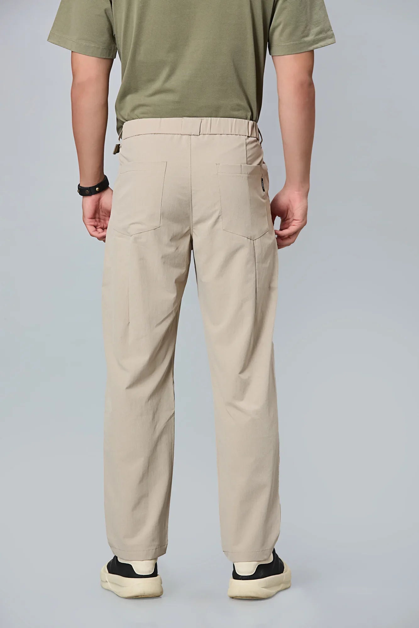 Men’s khaki formal trousers back view – 100% polyester with elastic waist.