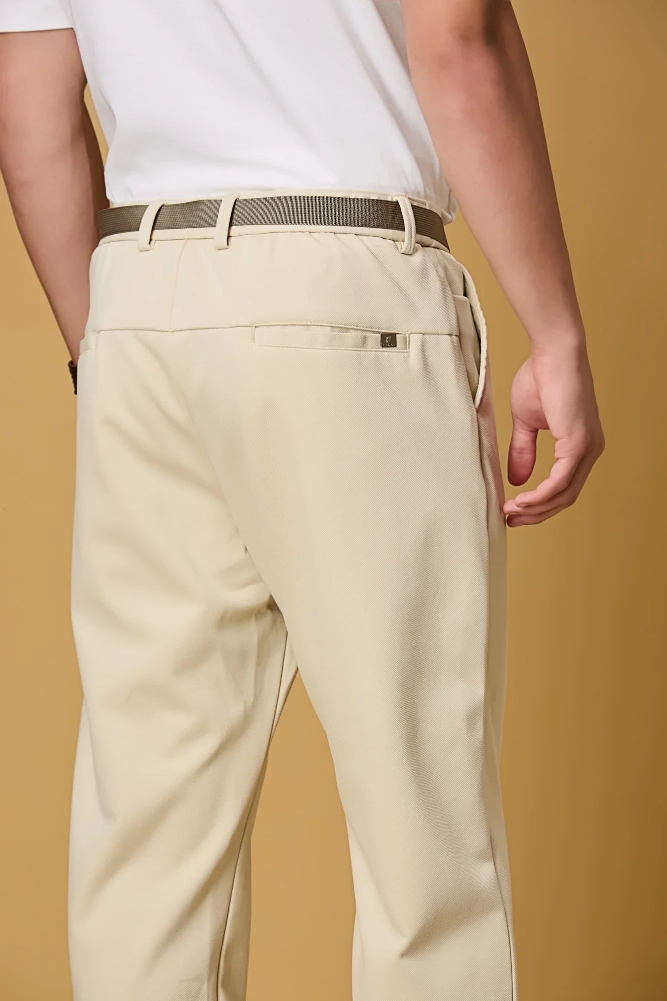 Close-up of beige Tencel cotton spandex fabric and belt detail – smooth stretch texture of LOFA men’s formal trousers.