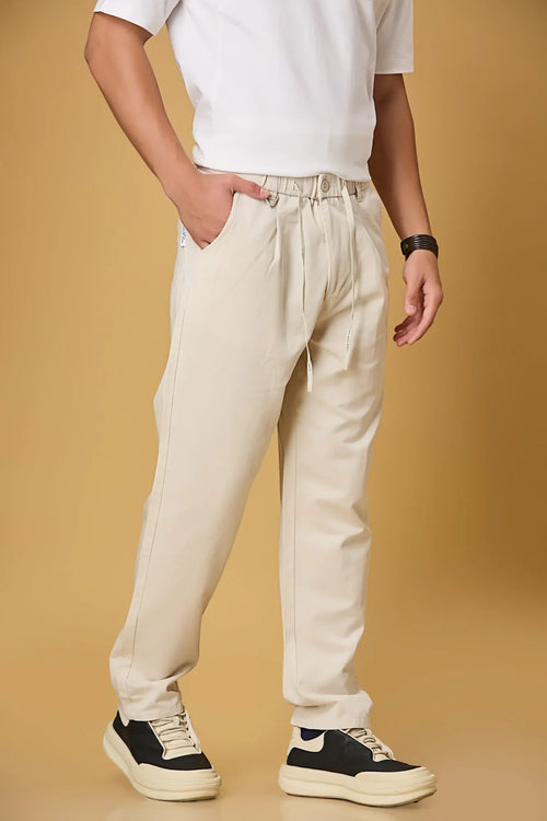 beige trousers side view showing smooth fabric and adjustable waist detail.