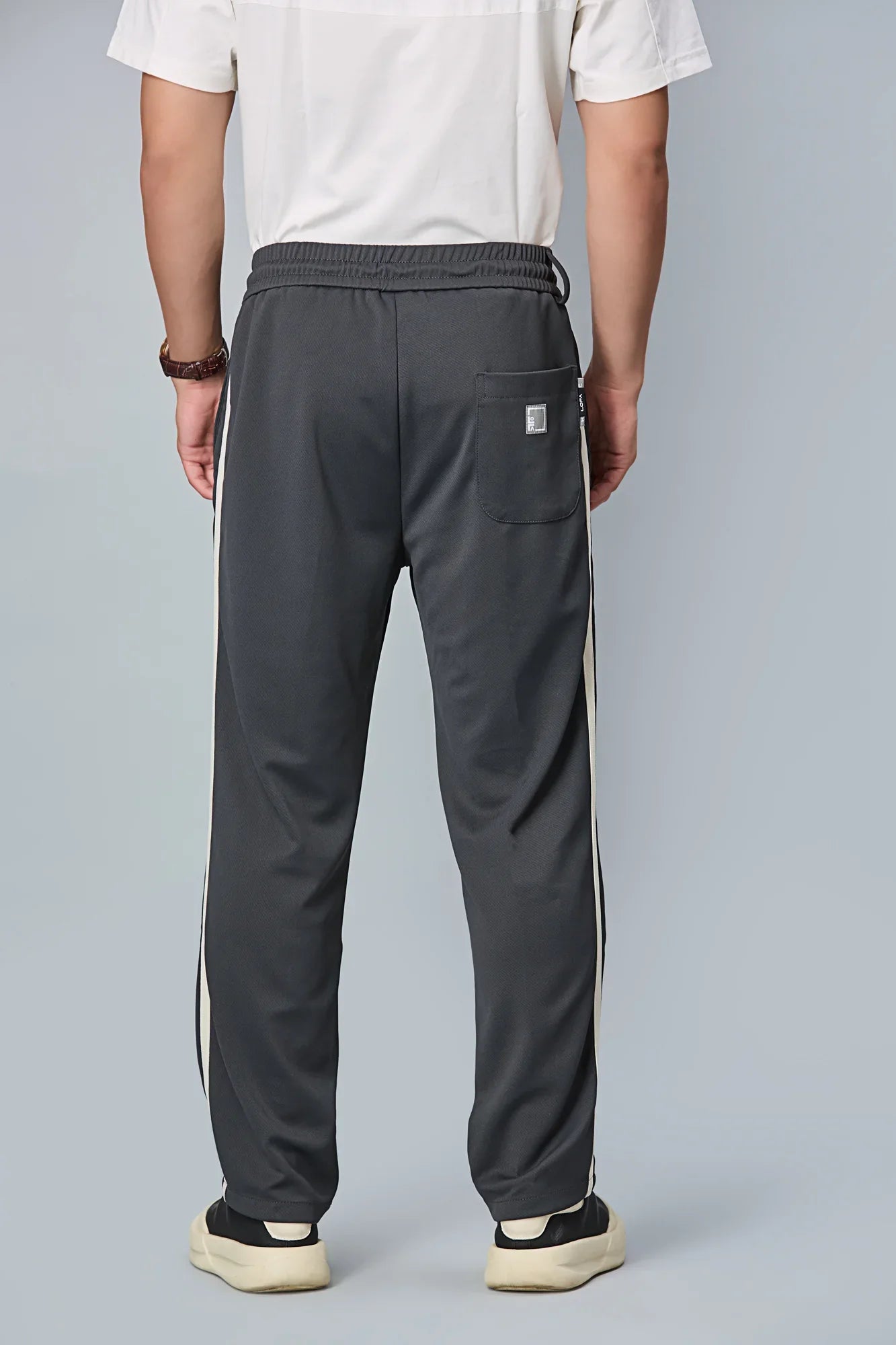 Back view of LOFA straight-fit men’s active pants – clean silhouette with wrinkle-resistant fabric.